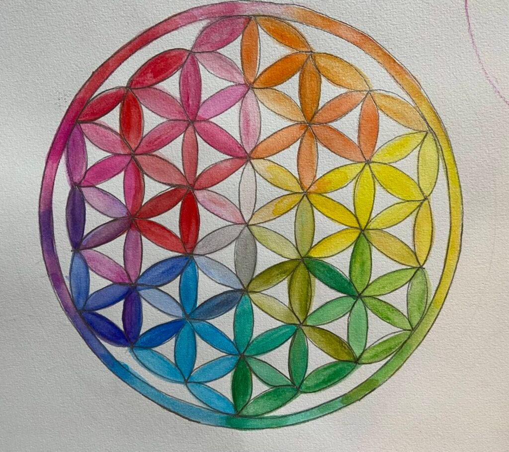 Fleur de vie dessinée à la main et colorée à l’aquarelle, symbole sacré de géométrie spirituelle.